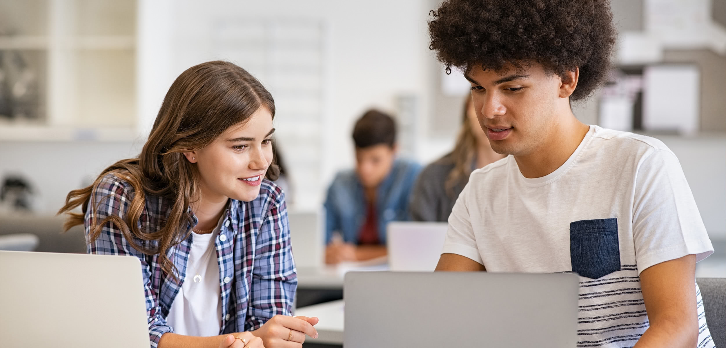 Students compare First Day Complete on laptops