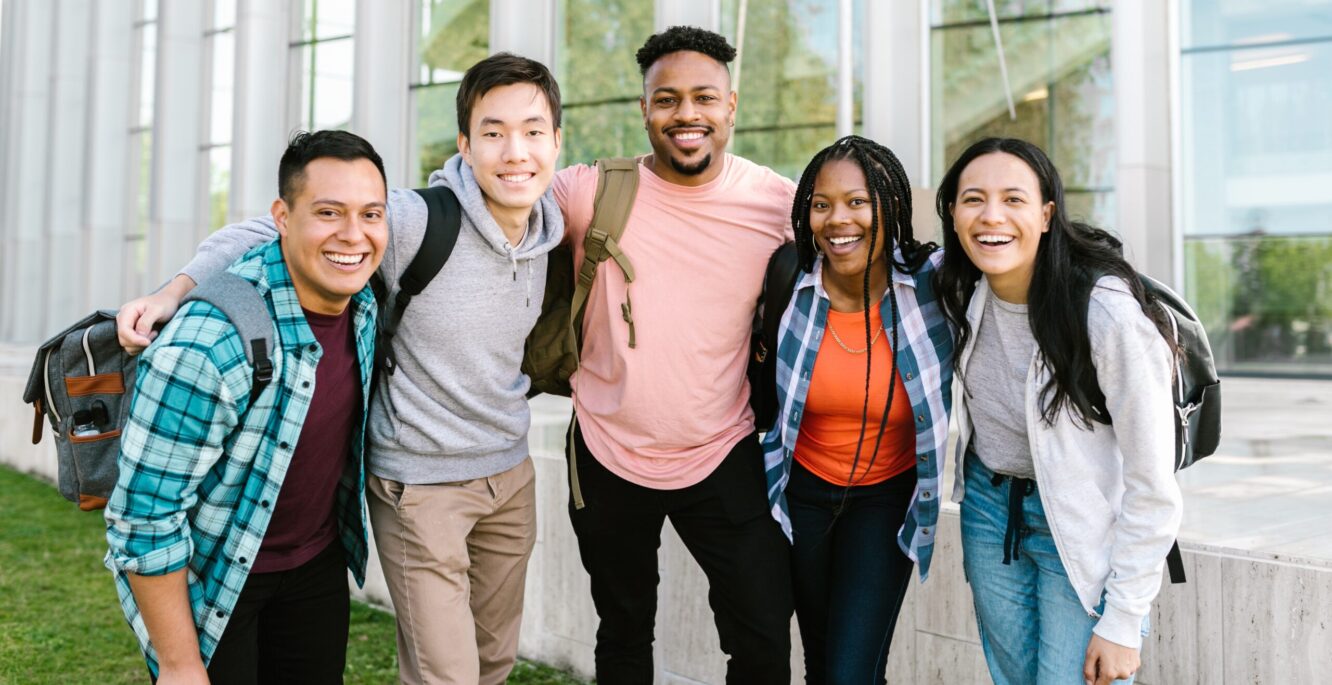 five students staying together outside the school building