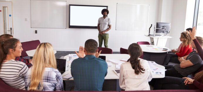 A student speaking before so many students sitting in a classroom