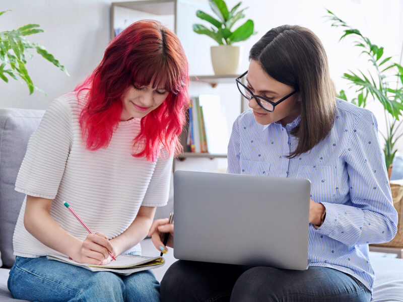 Faculty dictating notes to a student